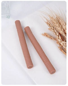 Close-up of spiral textured PVC simulation chocolate bars on a white minimalist base