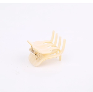 Close-up of the beige acetate hair claw clip featuring a durable transparent spring