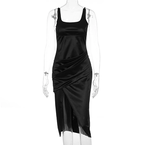 Detail view of black satin dress featuring sophisticated side pleats and slit design
