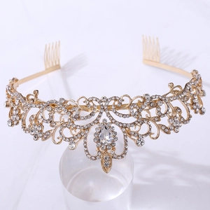 Detailed close-up of golden bridal tiara with sparkling crystal vine patterns and pear-shaped stone