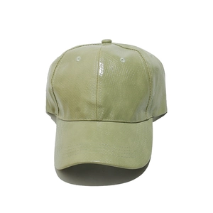 Detail of light green baseball cap featuring textured snakeskin pattern faux leather