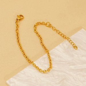 18K gold plated stainless steel O-chain bracelet with lobster clasp on marble background