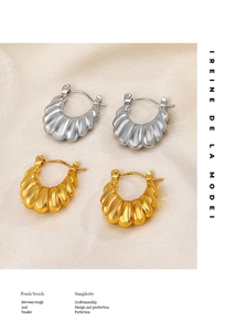 Detail of gold and silver croissant earrings with French vintage pleated textures