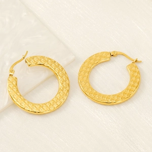 Golden stainless steel hoop earrings with star relief texture shown on marble background