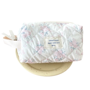 Quilted cotton floral makeup bag with cat print and woven handle in soft cream finish