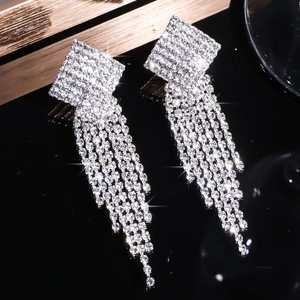 Sparkling silver square geometric long tassel drop earrings with crystals on black background