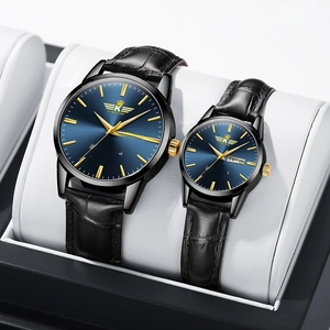 Detail of quartz couple watches with blue sunray dials and black leather straps