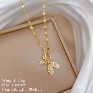 Detail view of gold leaf pendant necklace with micro-pave crystals and sizing specs