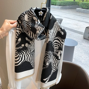Bohemian orange zebra print shawl scarf with tassels on white shirt and hanger
