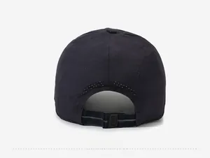 Detail of breathable laser-cut holes and adjustable strap on a dark blue quick-dry baseball cap