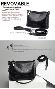 Detail view of black faux snakeskin handbag with detachable dual shoulder straps