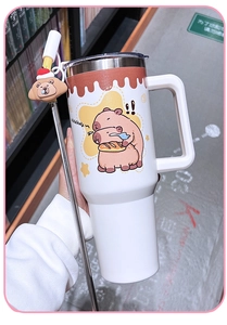 Ivory Kapibara tumbler with large handle, metal straw, and cute cartoon water pig print