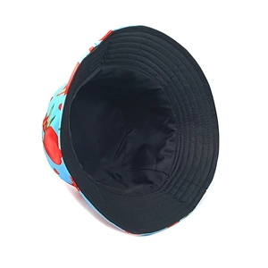 Close-up of reversible bucket hat featuring strawberry print on blue and black lining