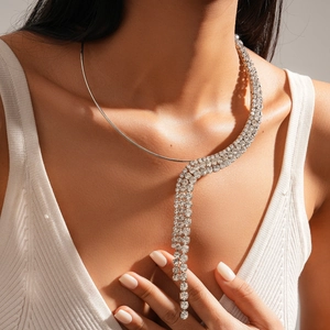 Detail of silver rhinestone fringe collar necklace with multi-row crystal tassels on model