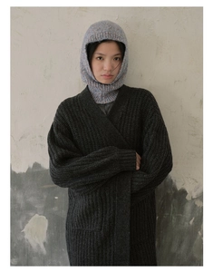Detailed texture of light blue flecked knit balaclava hood with colorful speckles