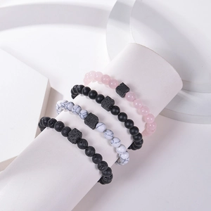 Detailed macro of natural lava rock, turquoise, and rose quartz beaded bracelets collection
