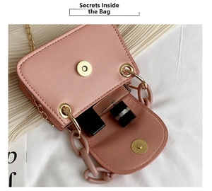 Pink jelly crossbody bag interior showing lipstick capacity with acrylic chain details