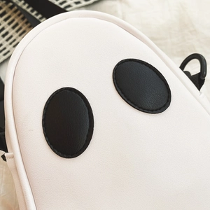 Close-up of ghost-shaped crossbody bag featuring white PU leather and black eye detail