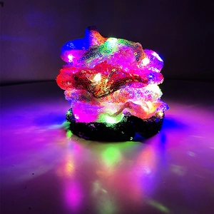Macro shot of black sequin LED scrunchie with glowing colorful RGB fiber optic lights
