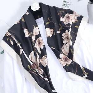Elegant 90cm square silk scarf with green plum prints hanging on a white shirt