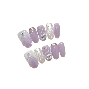 Handmade swan press-on nails with 3D lavender cat-eye and quilted patterns on white background