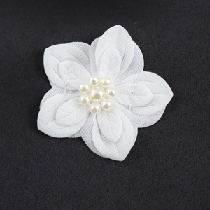 Elegant white floral strap mini dress with waist cinch and layered petal details