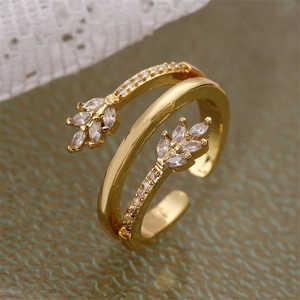 Detailed view of adjustable golden double-layer ring with sparkling zircon leaf patterns