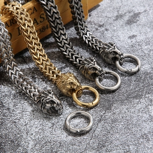 Punk style lion head bracelet in stainless steel with braided wheat chain link design