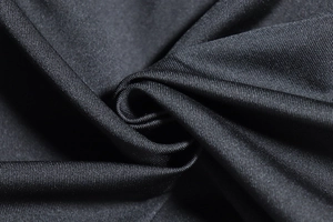 Detailed view of black knitted fabric texture with elegant pleats and soft sheen