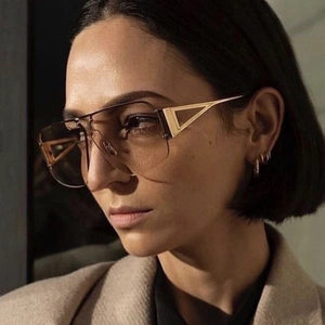 Detail of square pilot sunglasses with gradient lenses and gold hollow triangle temple