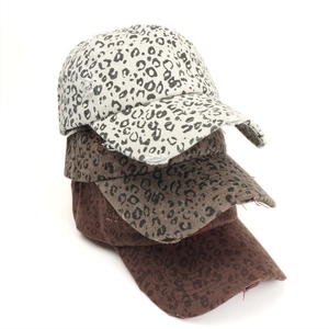 Vertical stack of distressed leopard print baseball caps in beige, olive, and brown