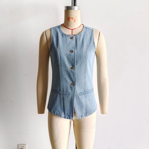 Detail view of light blue denim vest showing crew neck and single-breasted button closure