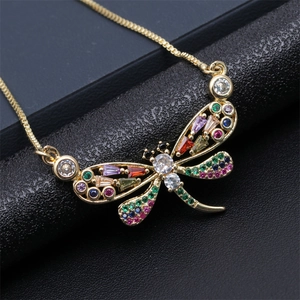 Exquisite gold dragonfly necklace with colorful zircon stones on black leather background