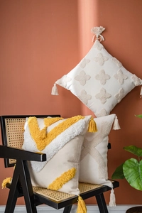 Detailed view of Moroccan style tufted cushions with geometric patterns and fringe tassels