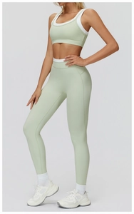 Detail of high-stretch sage green ribbed yoga set featuring contrast white trim and racerback