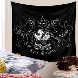 Detail of a Cat Coven black tapestry with witchy cats and moon graphics for wall decor