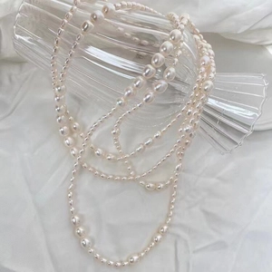 Natural freshwater pearl necklace with long multi-layer design on white fabric