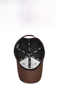 Detail view of brown baseball cap interior showing FBXS logo tapes and reinforced seams