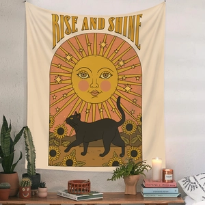 Detail view of boho tapestry with sun and black cat under Rise and Shine text