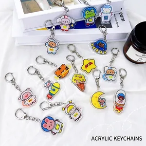 Detailed close-up of cute cartoon acrylic keychains with animal and space theme designs