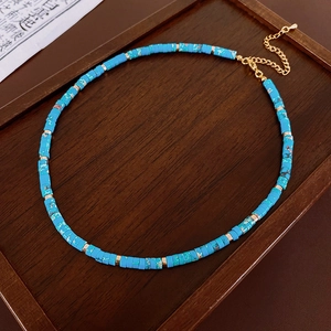Detailed view of Shoushan stone beaded necklace with blue turquoise texture on wood tray