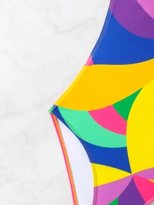 Detail of colorful geometric pattern swimsuit showing high-quality double stitching and lining