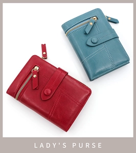 Detail of red and blue PU leather trifold wallets with buckle strap and zipper pocket