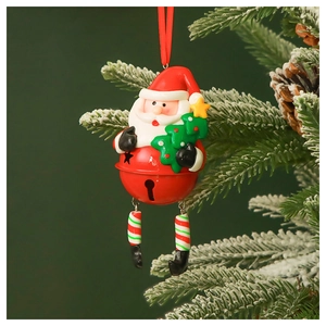 Detail of a Santa Claus bell ornament hanging on a snowy Christmas tree branch