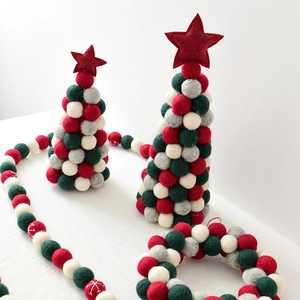 Handmade wool felt mini Christmas trees and colorful ball garlands for holiday tabletop decor