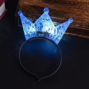 Blue LED glowing plastic crown headband for birthday parties in dark ambient lighting