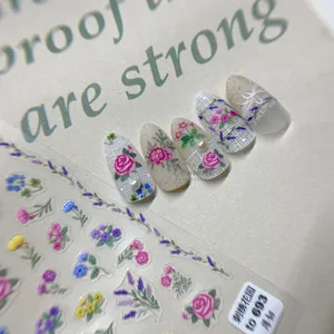 Detail of thin embroidery flower nail stickers showing pink roses on almond nails