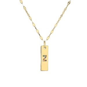 Macro shot of gold-plated pendant featuring letter Z set with colorful crystals