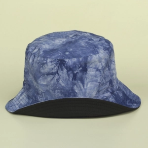 Detail of blue and white tie-dye bucket hat showing neat stitching and reversible black lining