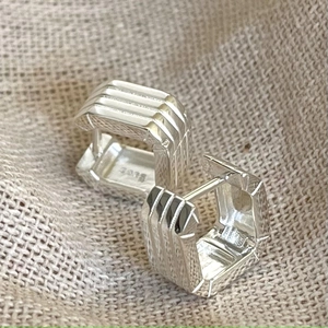 Detail view of 925 sterling silver rectangular earrings with vertical stripe texture
